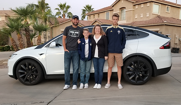 Steve and his family with their new Tesla.