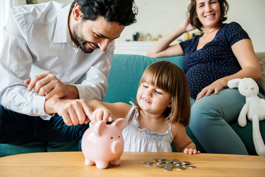 Parents teach their child about coins