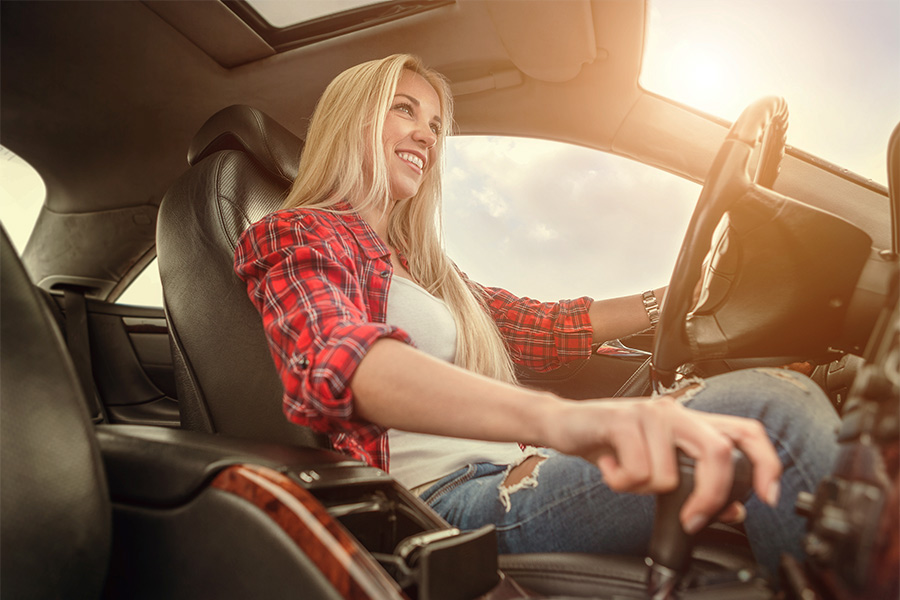 smiling woman driving car in arizona
