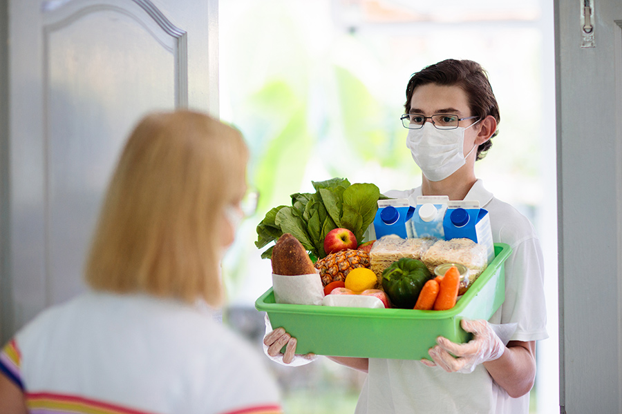 young man deliverying groceries during COVID-19