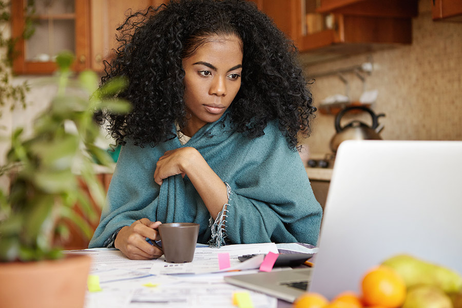 sitting at the kitchen table going over her finances and setting her financial goals