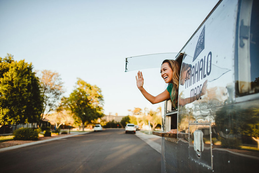 Lady La waving from the Mahalo Made Airstream