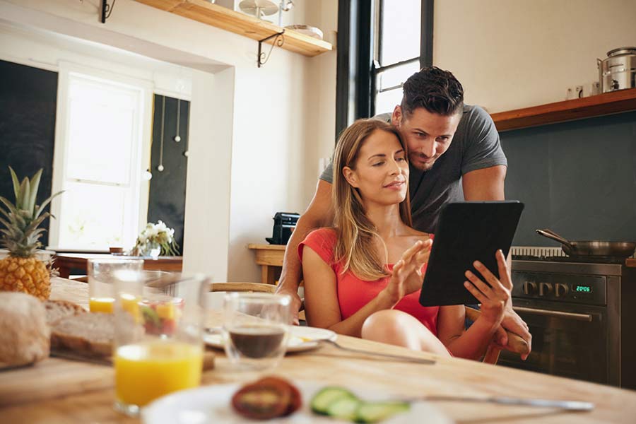 A couple in a house pondering a cash out refinance
