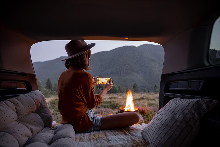 young woman camping in her van