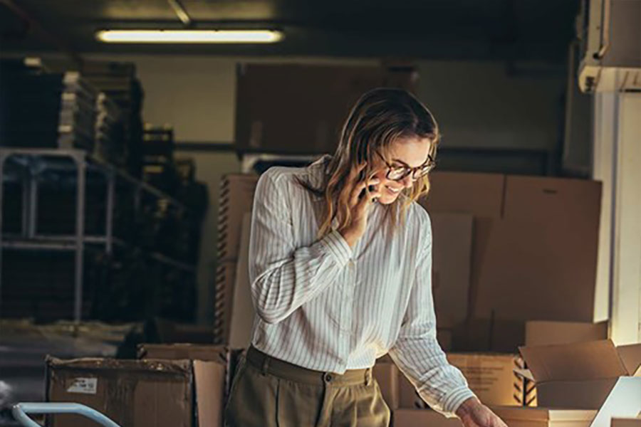 woman on the phone managing orders for her small business