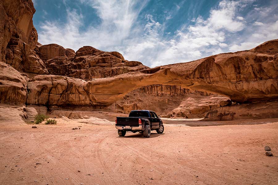 Newly refinanced pickup truck driving offroad in the desert.