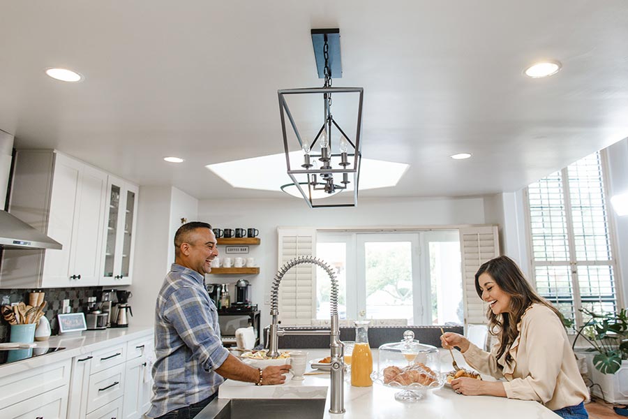 happily married couple making each other laugh in the kitchen