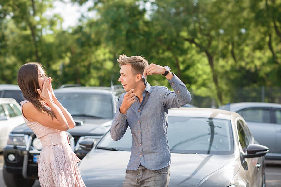 A couple is excited that they just bought a used car.