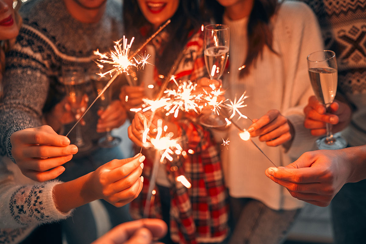 friends celebrating New Year's with sparklers