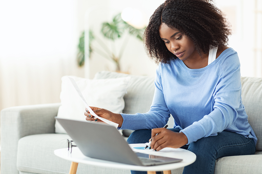 young woman creating a budget and preparing for a recession