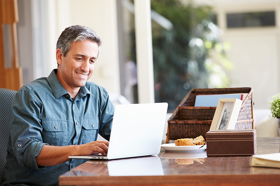 man checking credit score on laptop