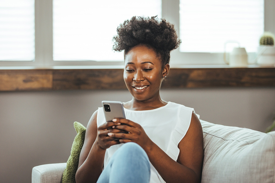 Person scrolling social media on a phone and looking to avoid personal finance myths.