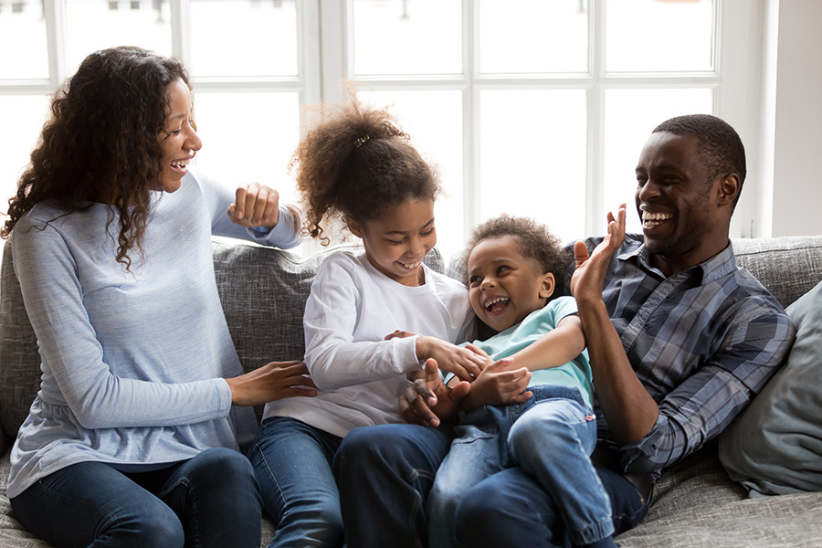 happy family of four laughing