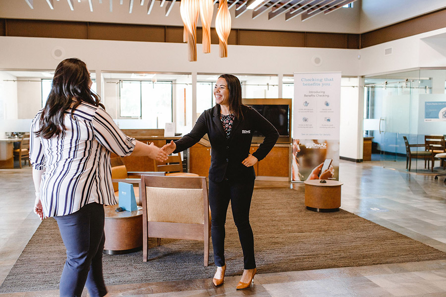 Associate shaking a member's hand. Credit unions deliver personalized banking in the digital age.