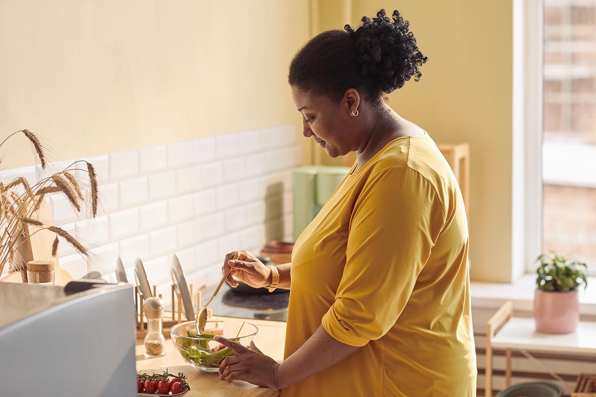 woman saving money by cooking at home instead of going out to eat