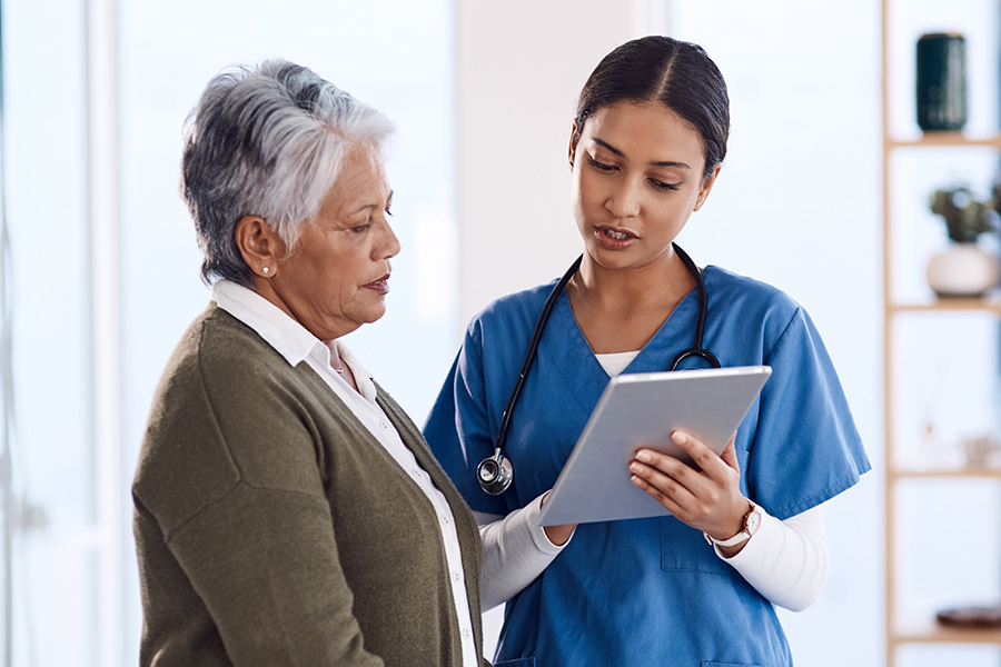 Nurse talking to patient. Does medical debt affect your credit score?