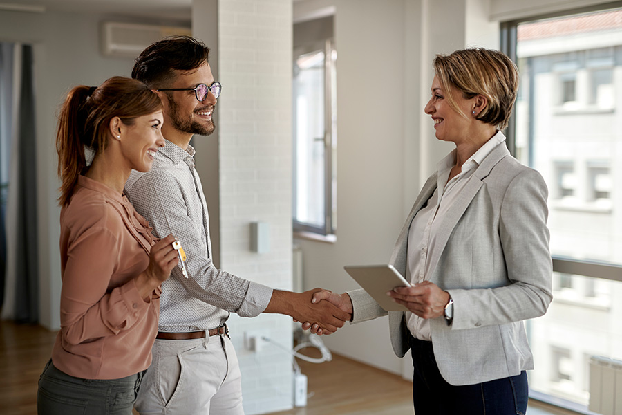 Real estate agent and happy couple. Professionals in the homebuying process