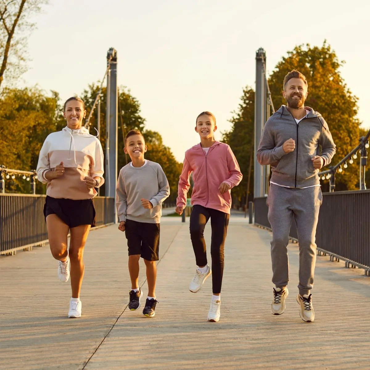 Family jogging on bridge